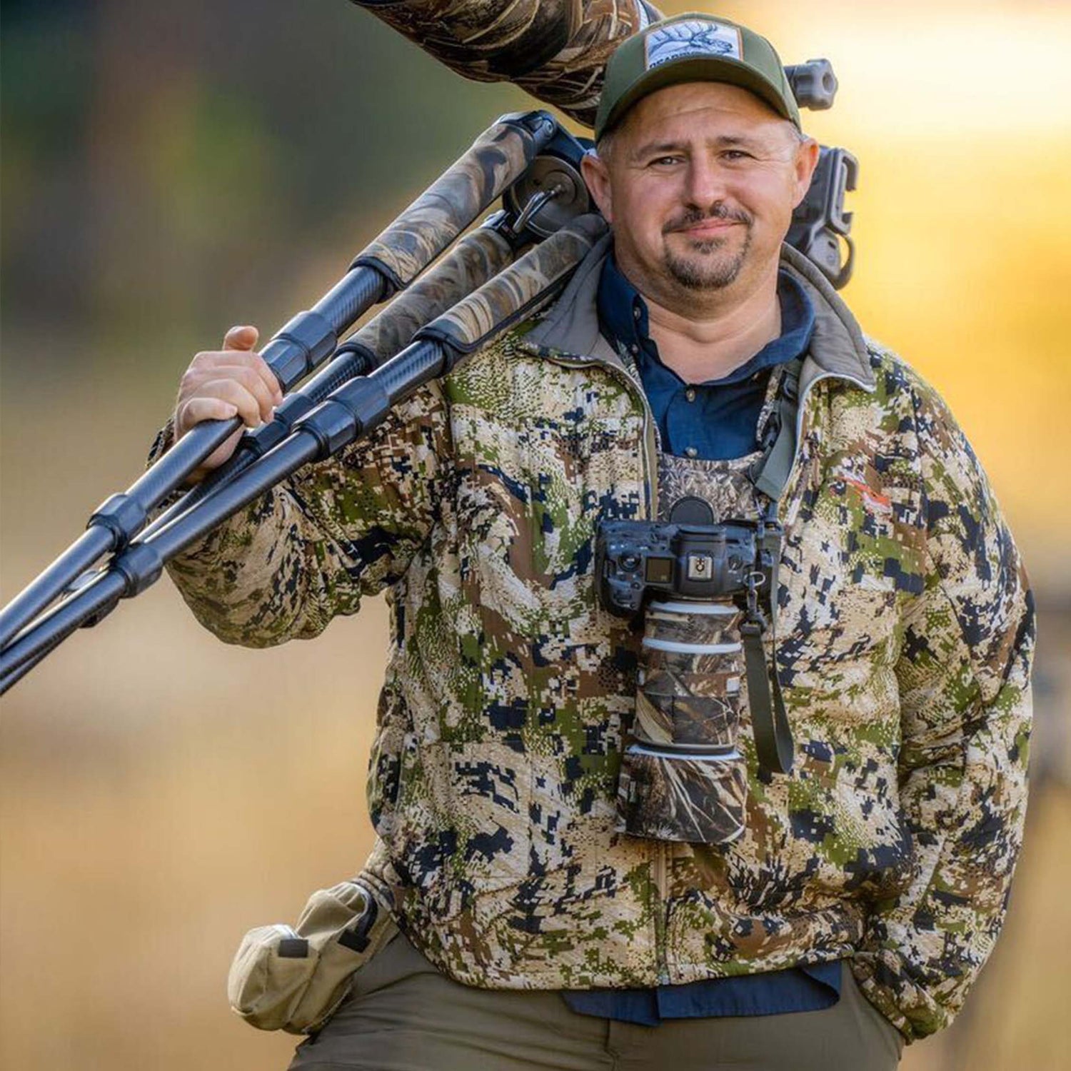 Wildlife photographer using a camera strap to hold his photography gear