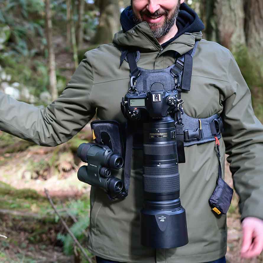 Man wearing a Cotton Camera Carrying System camera harness and binocular harness - also known as a Cotton Carrier.