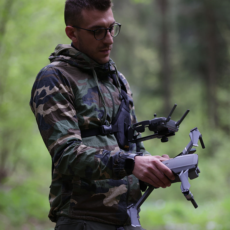 Man wearing a Cotton Camera Carrying System drone harness - also known as a Cotton Carrier