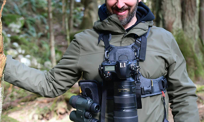 Man wearing a pair of binoculars in a bino harness