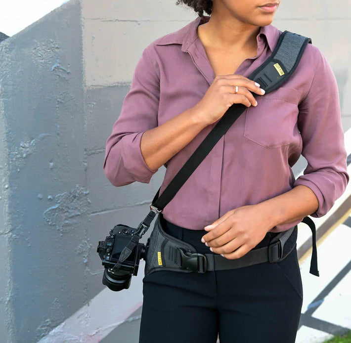 Woman wearing a camera sling while photographing